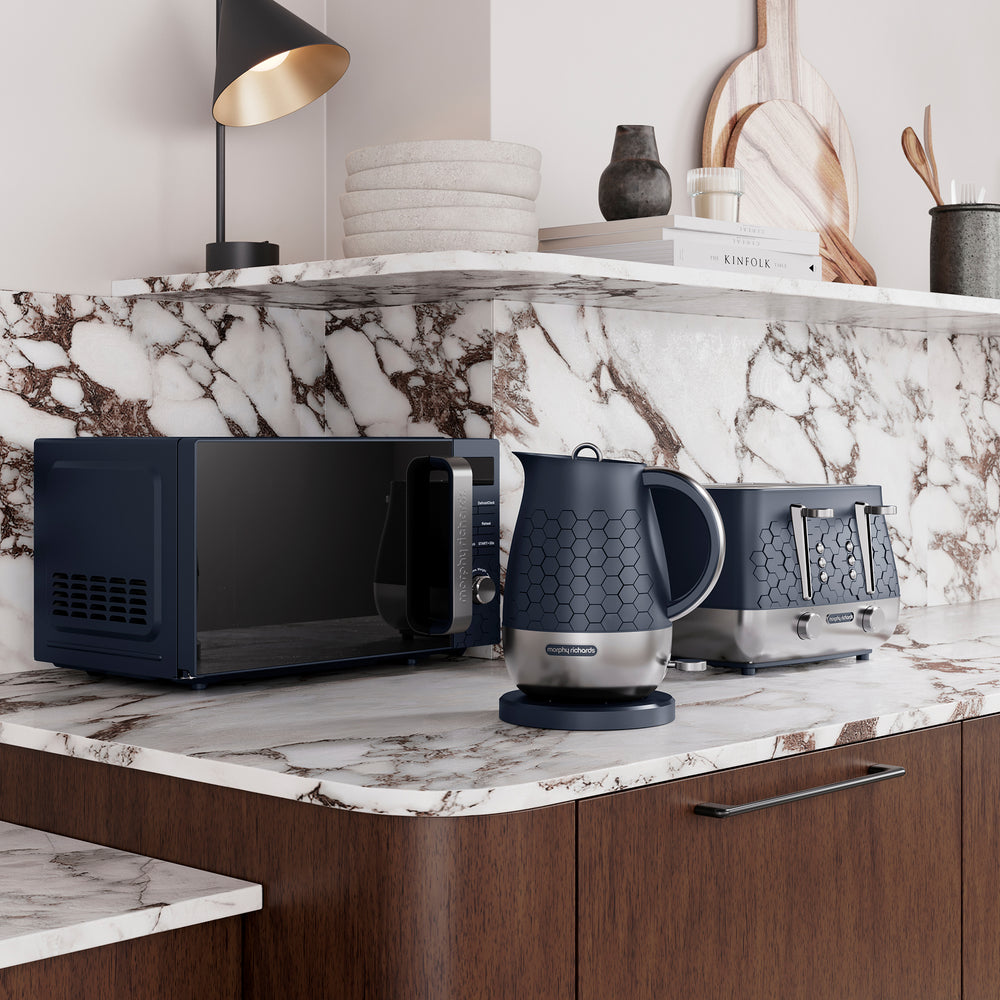 Kitchen counter with Morphy Richards Cassini microwave, toaster, and kettle on a marble countertop.