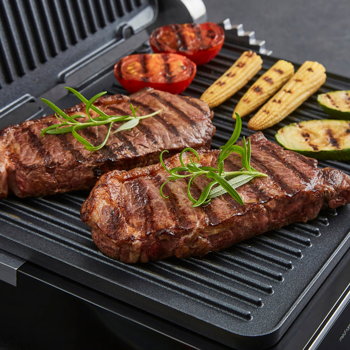 Grilled steaks with vegetables on a grill pan