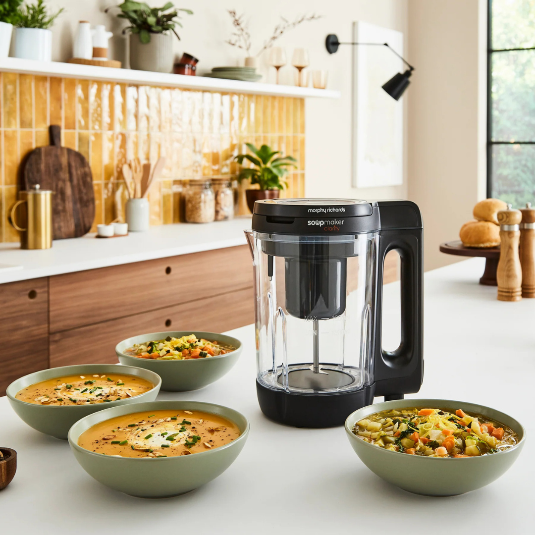 Morphy Richards soup maker and bowls of soup on a counter.